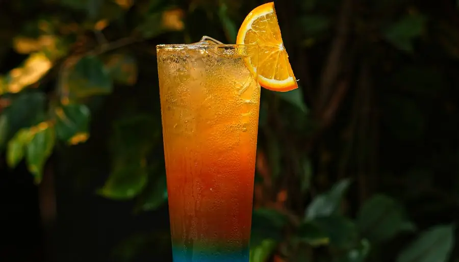 Layered orange mocktail with an orange slice
