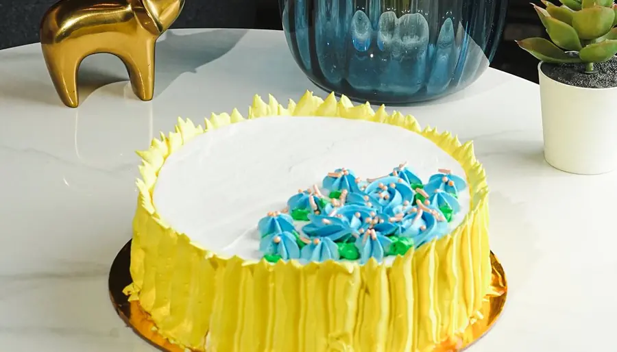 Yellow butterscotch cake with blue flowers
