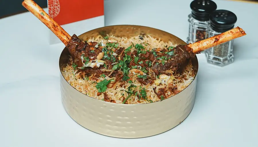 Nalli gosht biryani in a brass handi